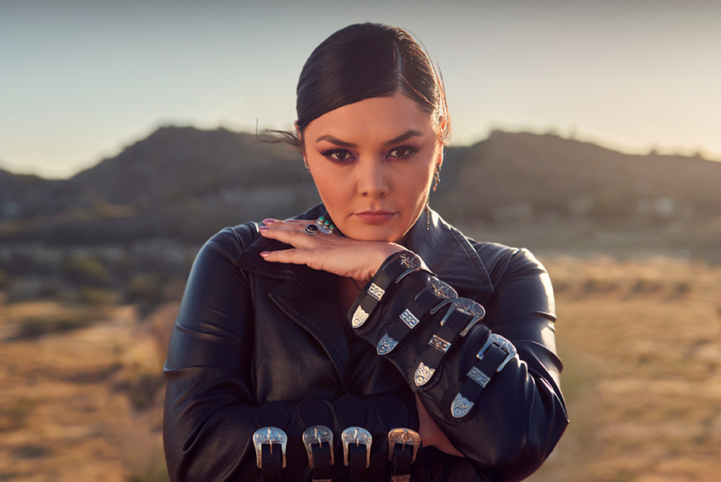 Headshot of Yuridia as she faces the camera, the desert seen in the background